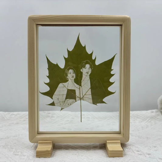 Custom laser-carved portrait on natural maple leaf in wooden frame