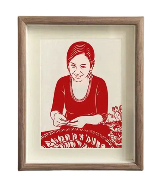 Custom hand-cut paper portrait artwork framed in natural wood